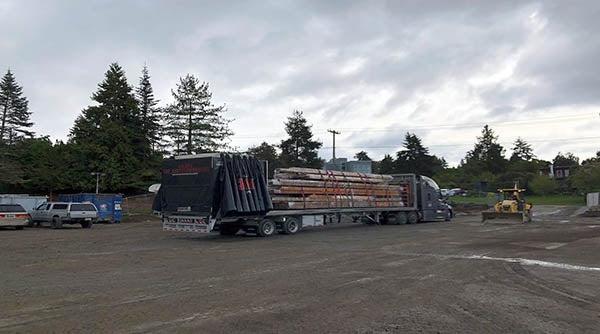 一辆平板半卡车上装载着木材和其他材料