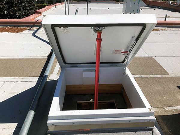 an open roof hatch on a flat roof
