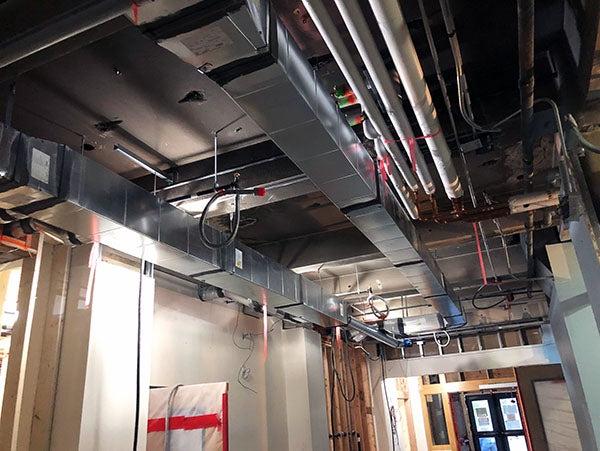 metal ductwork in the ceiling next to large pipes